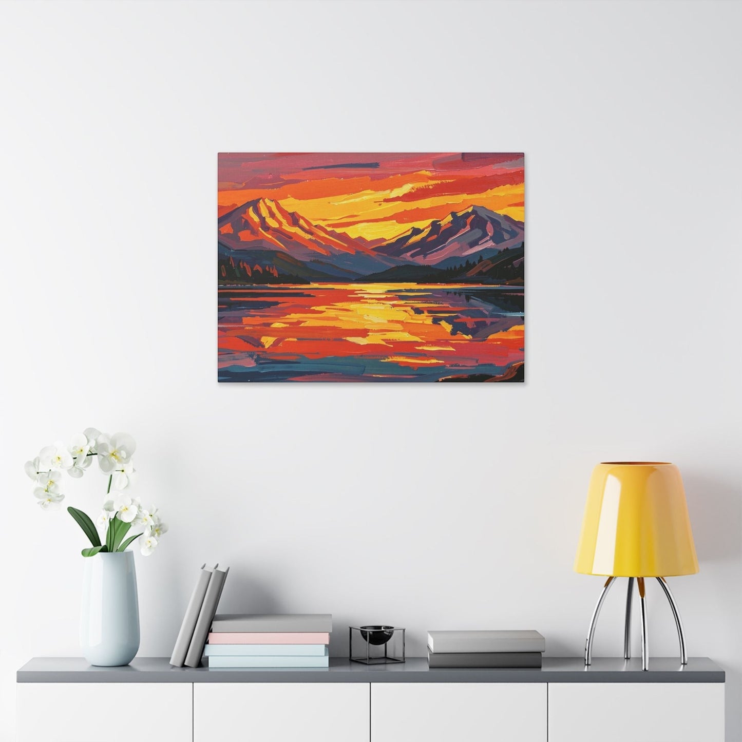 Chromatic canvas print of a vibrant sunset over mountains and a lake, featuring bold orange and indigo brushstrokes.