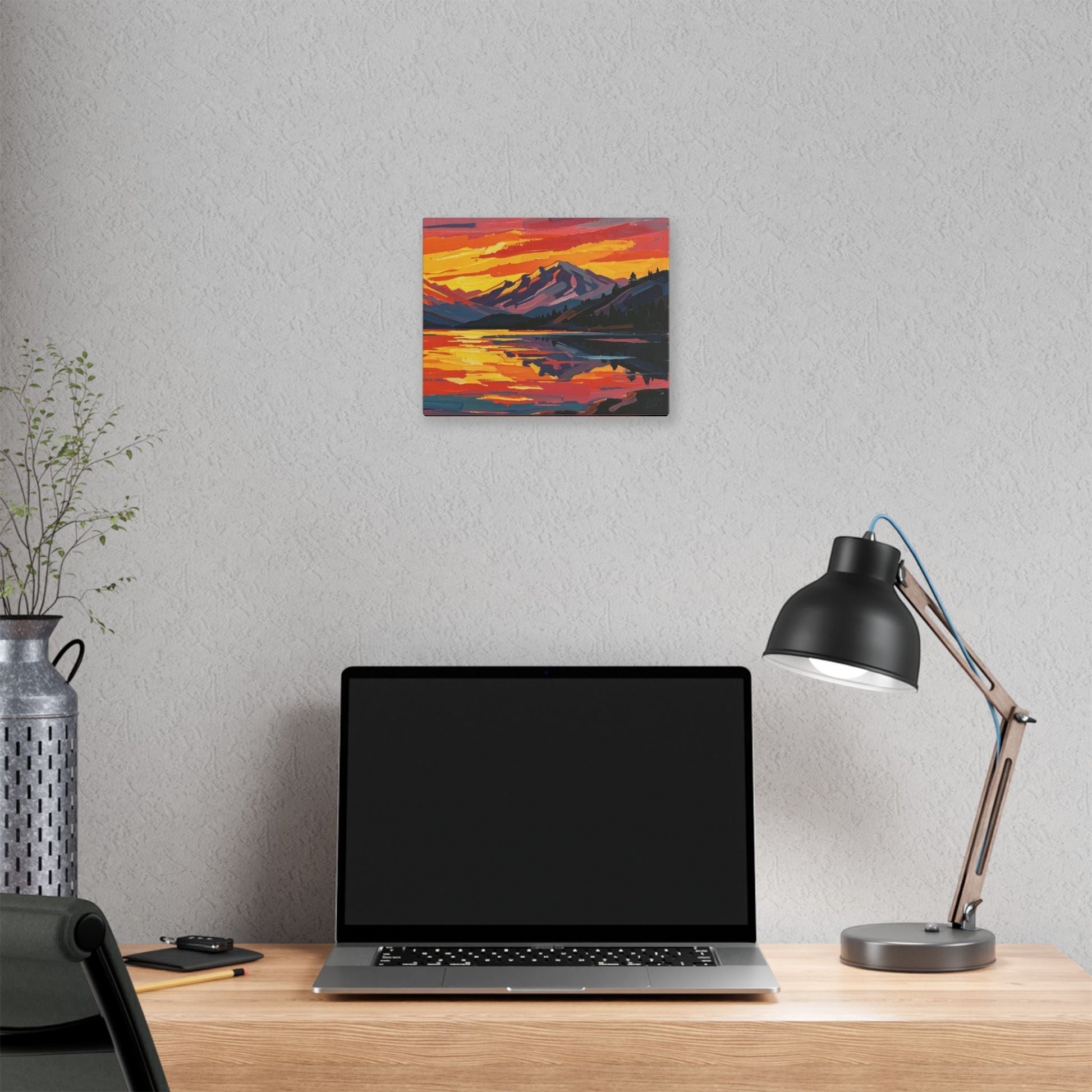 Chromatic sunset mountain lake canvas print with vibrant orange and indigo brushstrokes hanging on a grey office wall.