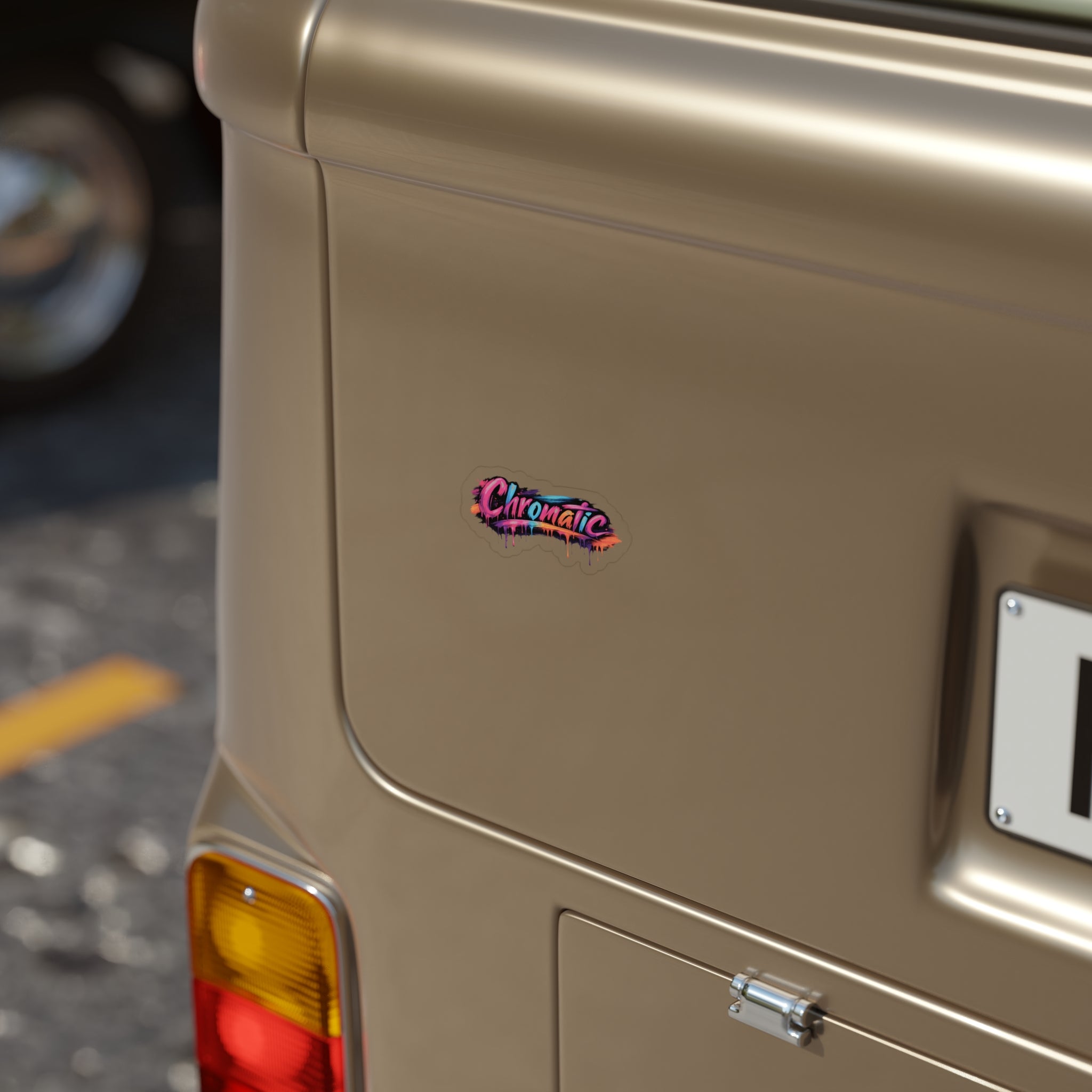 The rear corner of a vintage beige vehicle features a small, vibrant “Chromatic” sticker that pops against the muted paint. The multicolored design adds an artistic, expressive touch to the smooth metal surface. A rear light, partial license plate, and a yellow‑lined road set the scene, highlighting how bold, colorful branding transforms everyday objects into creative, fashion‑driven statements.