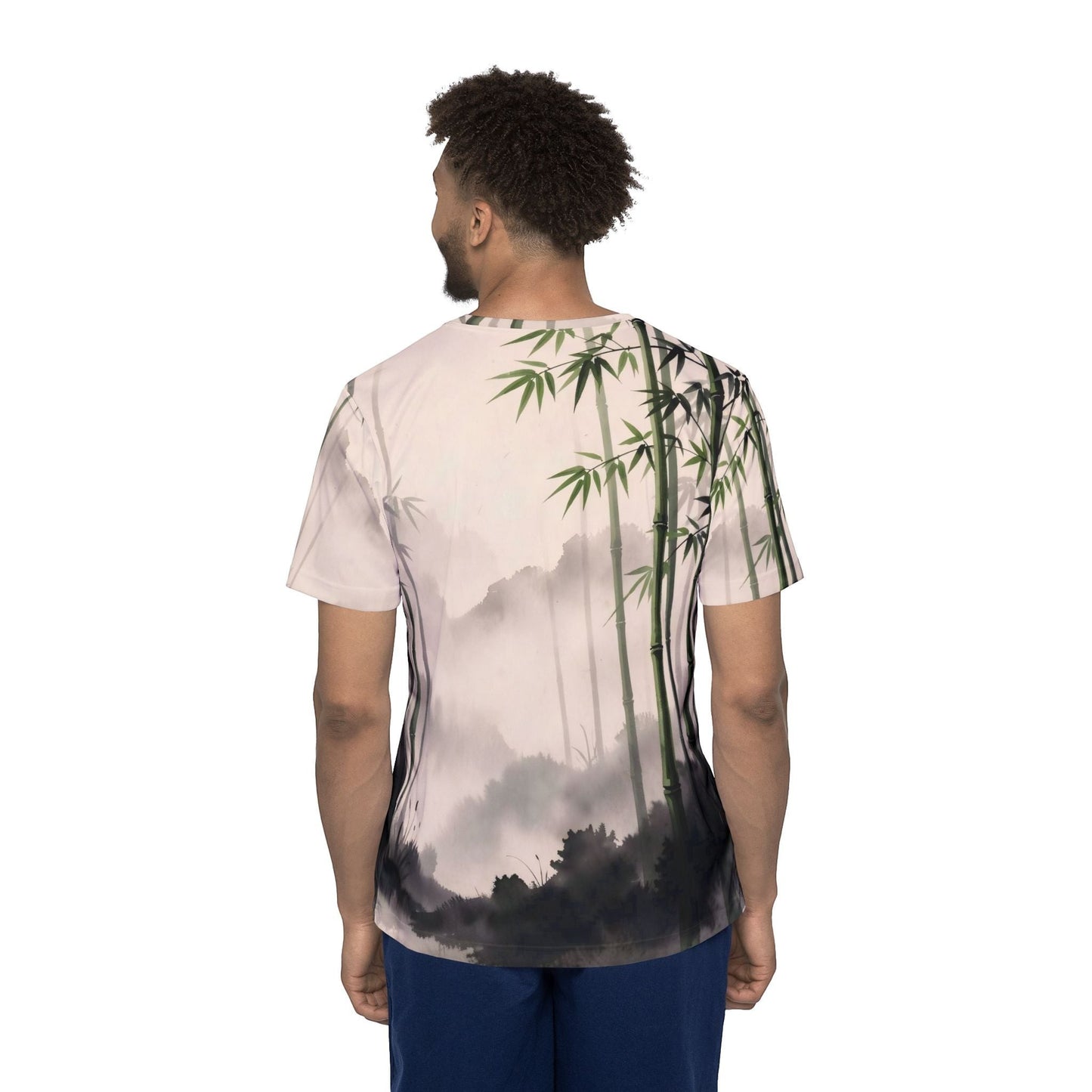 Back view of a man wearing a Chromatic Bamboo Mist sports jersey with a green and charcoal zen bamboo forest print.