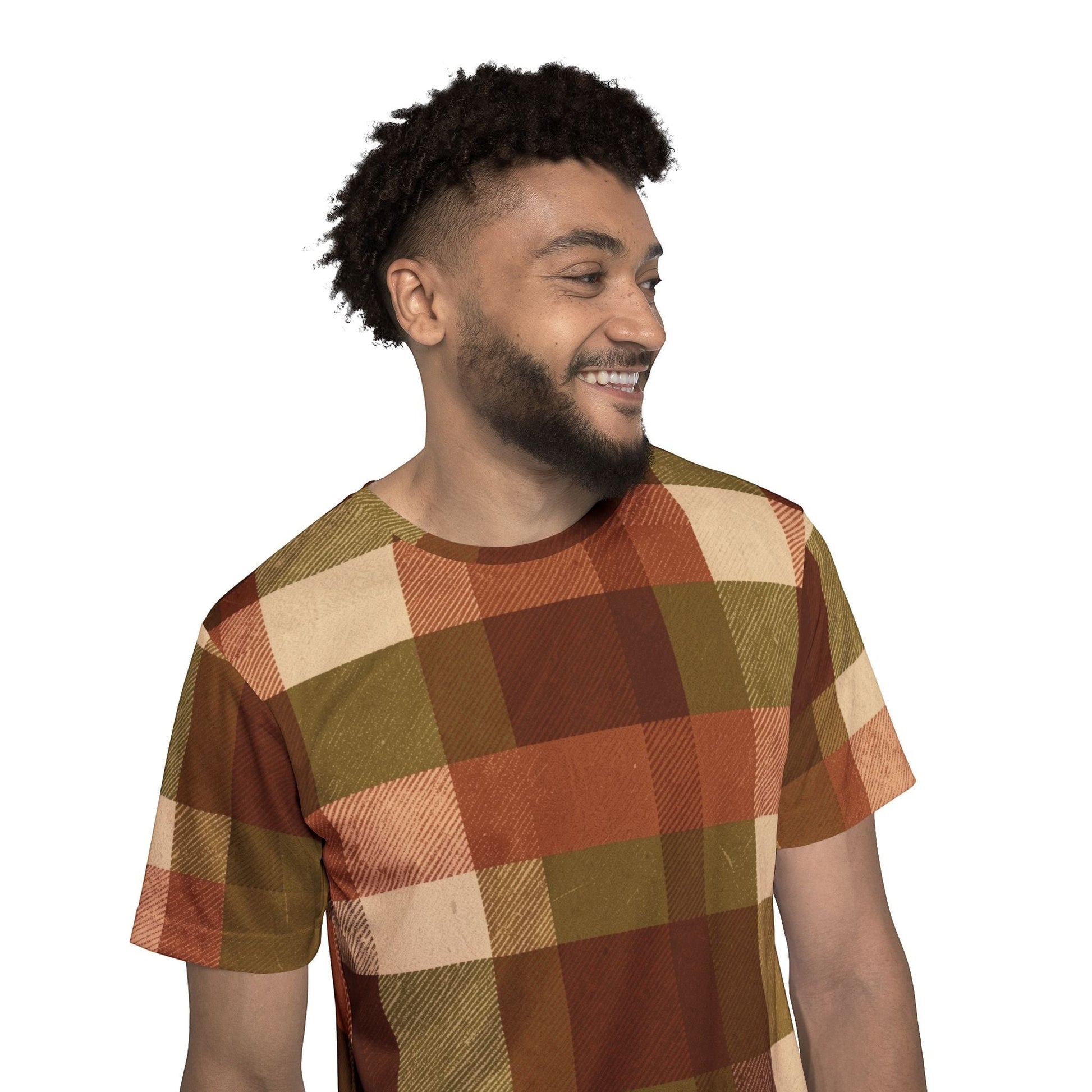 A smiling man wearing a Chromatic plaid sports jersey in autumn brown, rust, olive, and cream moisture-wicking fabric.
