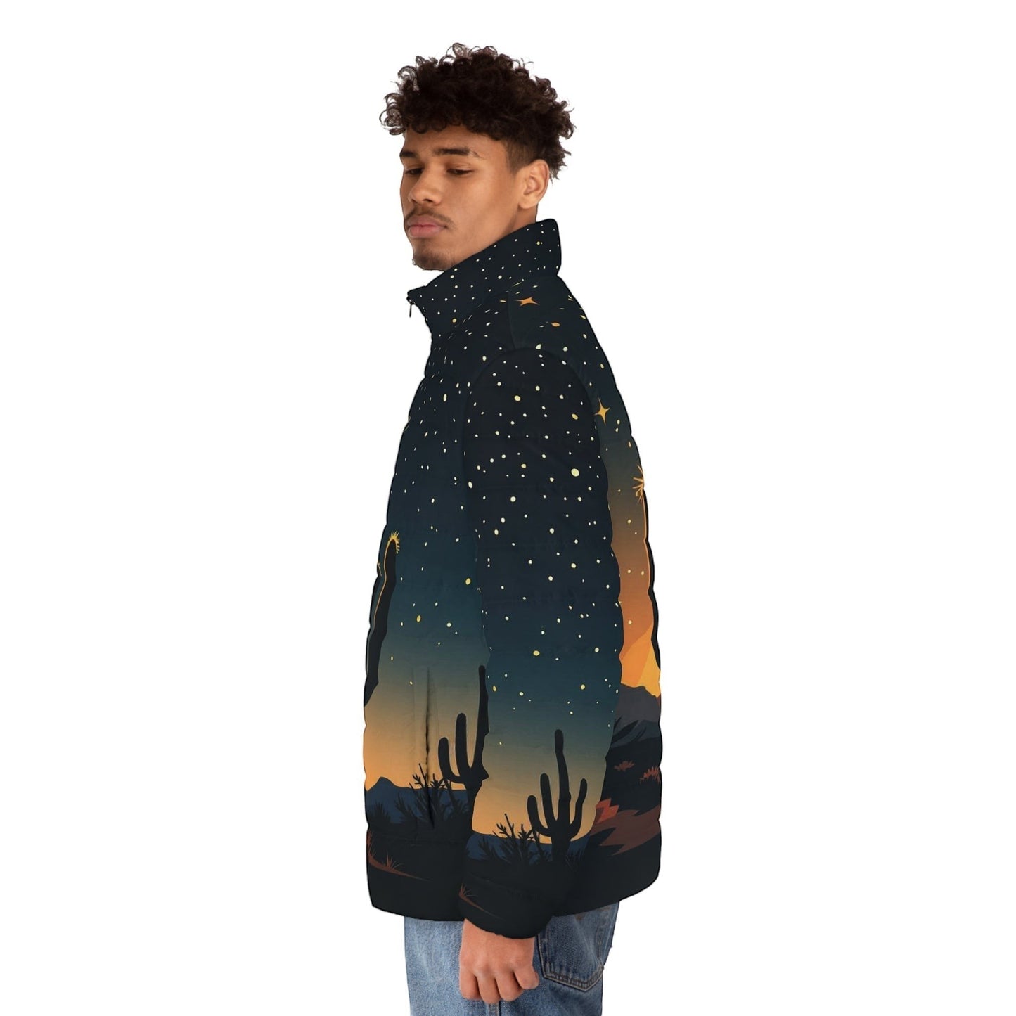 A man wearing a Chromatic puffer jacket featuring a desert cactus silhouette at dusk with a starry night sky print.