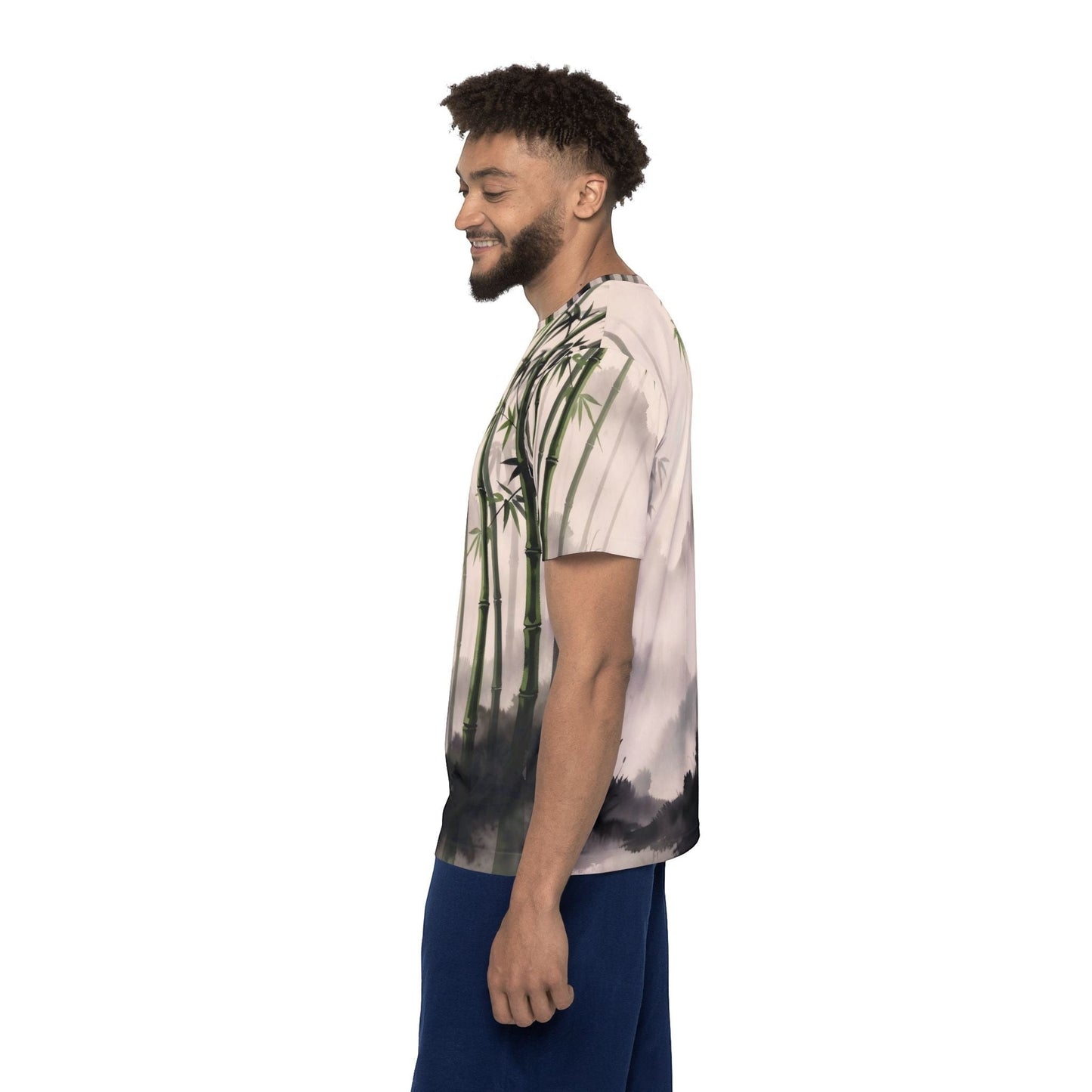 A man wearing a Chromatic Bamboo Mist sports jersey featuring a green and charcoal zen bamboo landscape print.