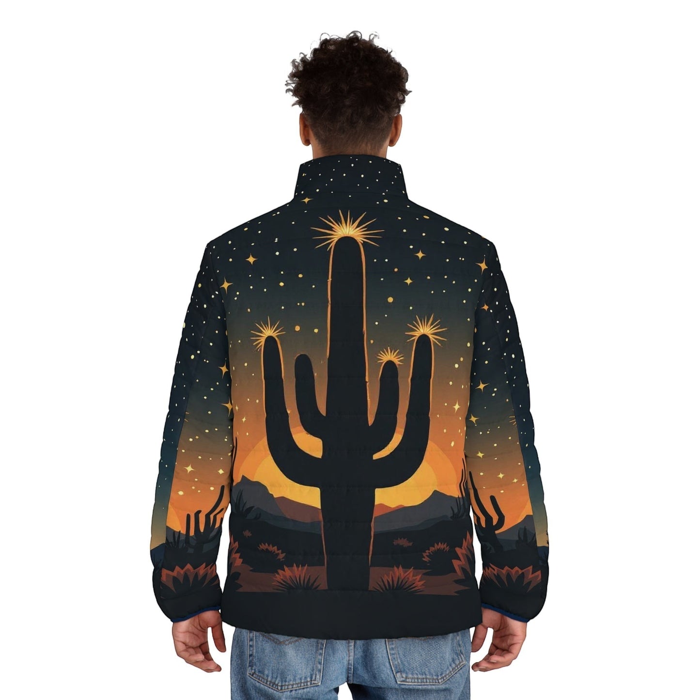 Back view of a man wearing a Chromatic puffer jacket featuring a desert cactus silhouette at sunset with starry sky.