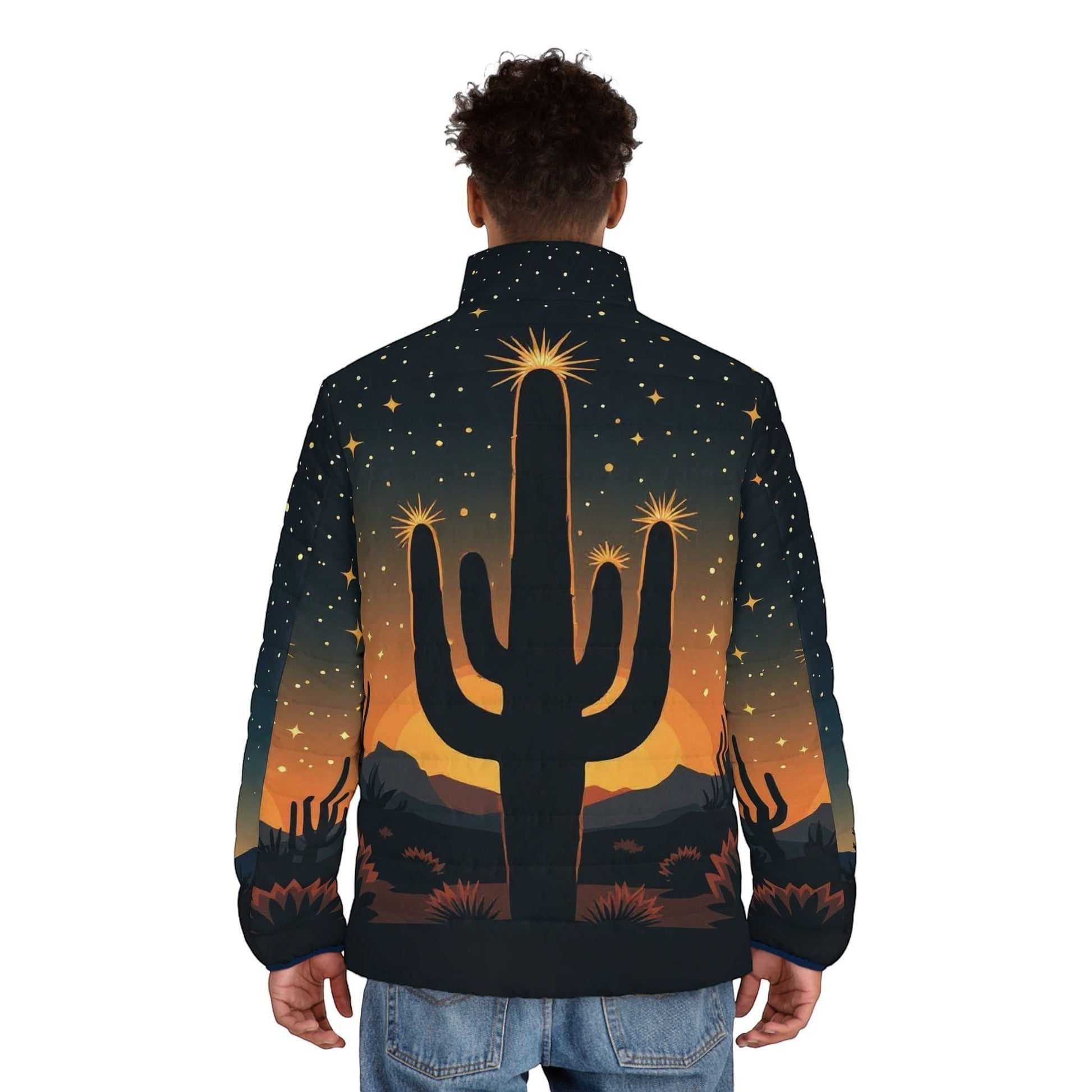 Back view of a man wearing a Chromatic puffer jacket featuring a desert cactus silhouette at sunset with starry sky.