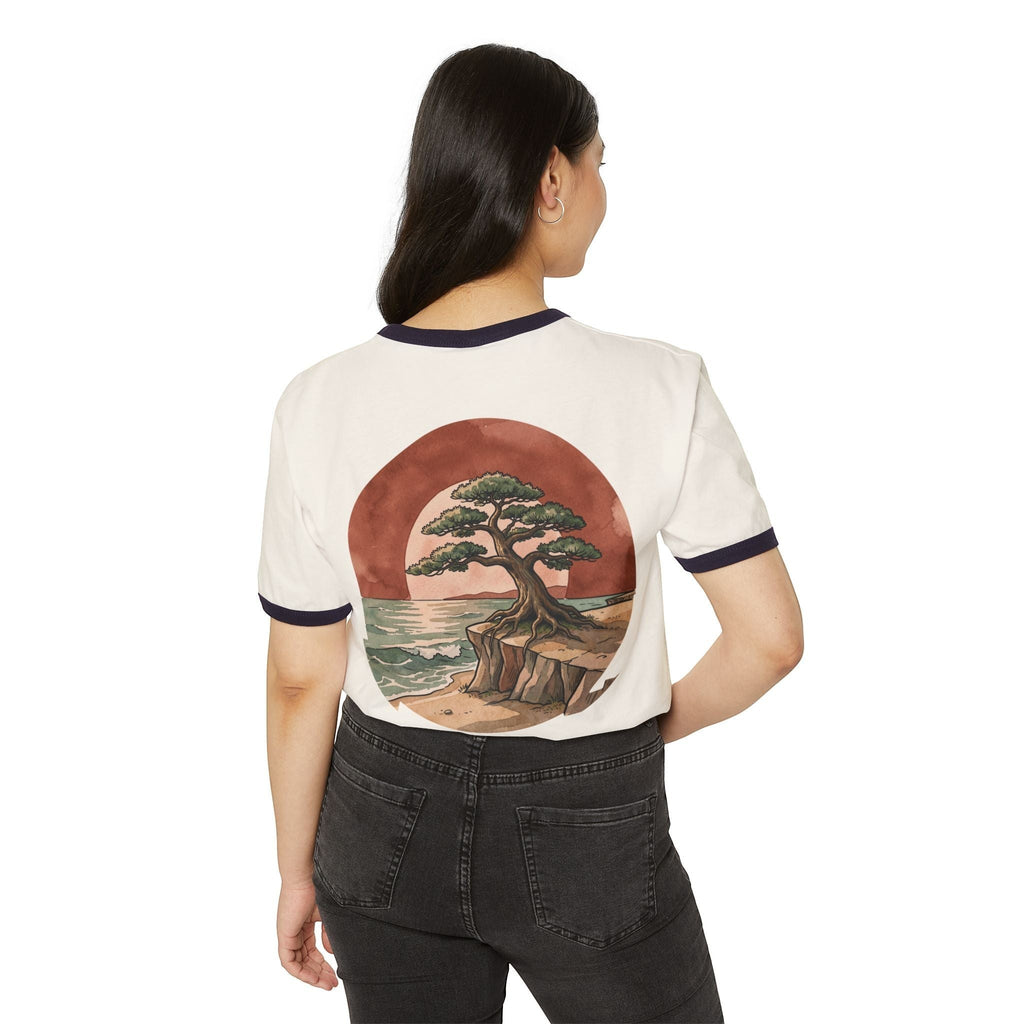Woman wearing a Chromatic retro ringer tee with a bonsai tree and ocean sunset graphic on the back.