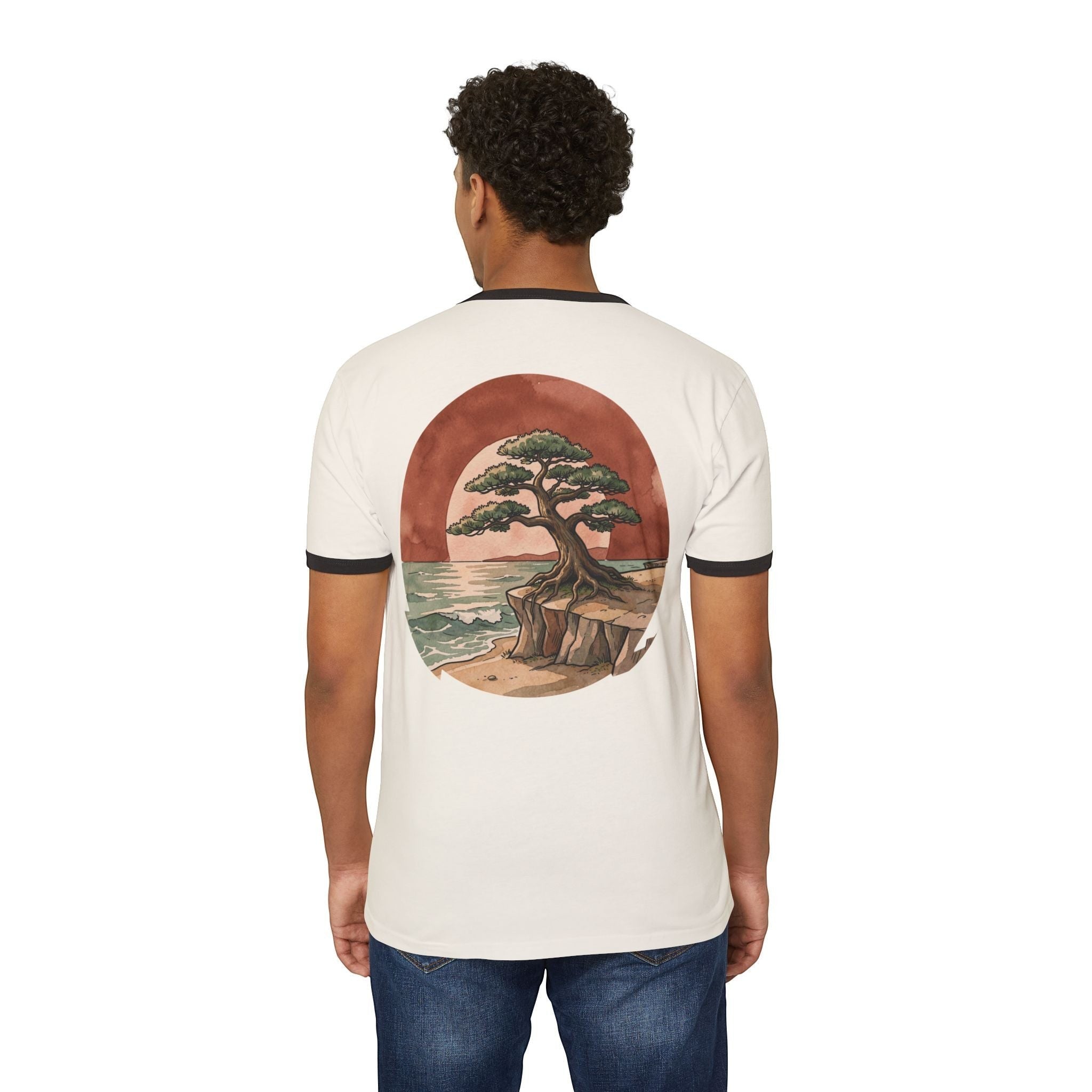 Chromatic retro ringer tee with a bonsai tree on a cliffside graphic on the back, worn by a man in blue jeans.