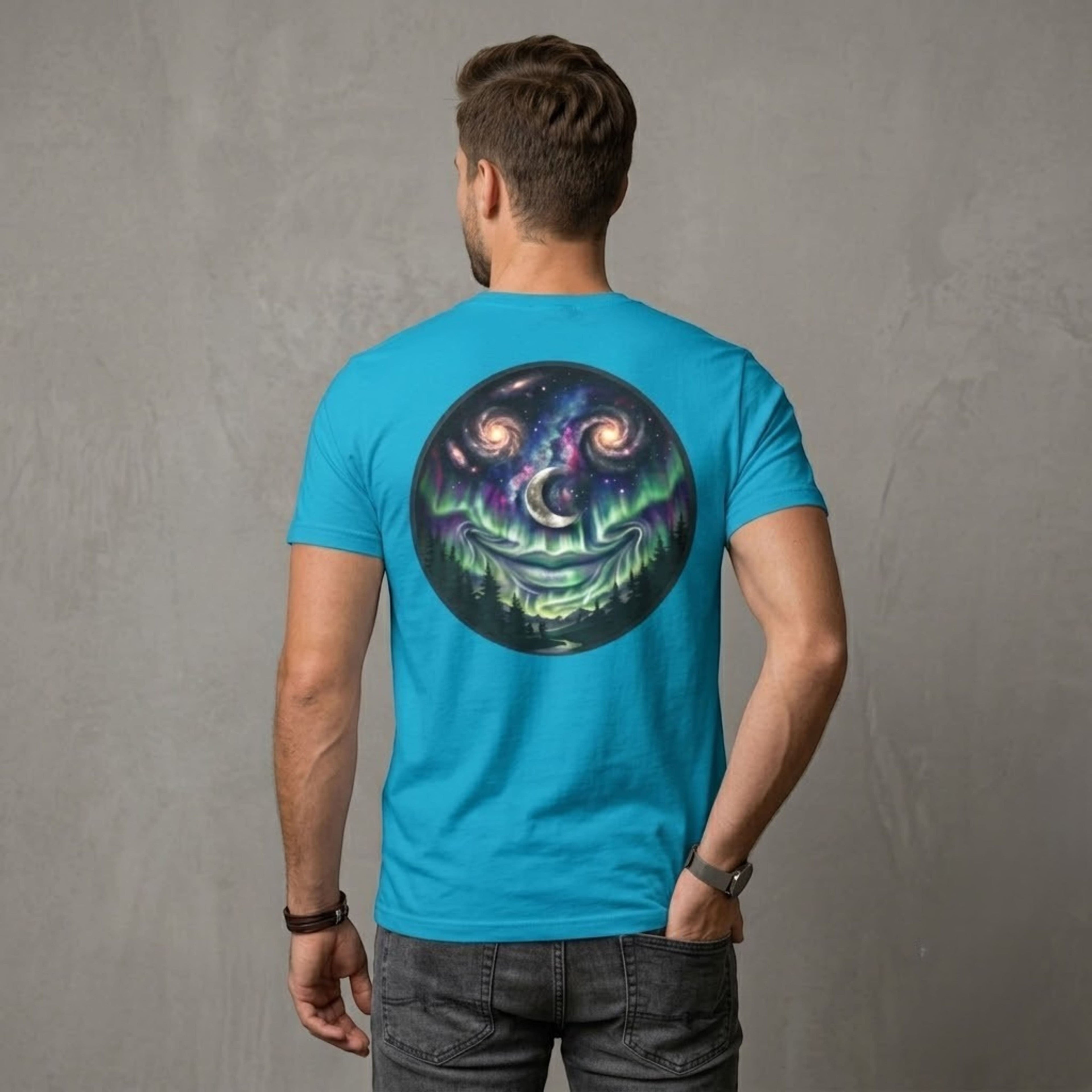 Man wearing a bright blue Chromatic cotton t-shirt with a cosmic galaxy smiley face graphic on the back.
